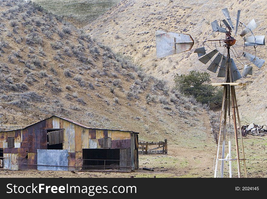 Shot of a Windmill ans an old shed located in California's central valley. Shot of a Windmill ans an old shed located in California's central valley.