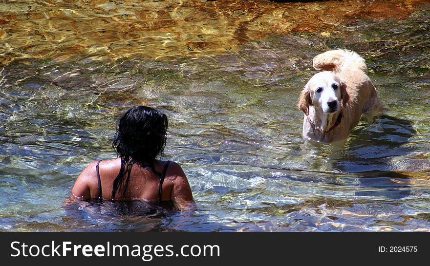 Woman and her dog swimming