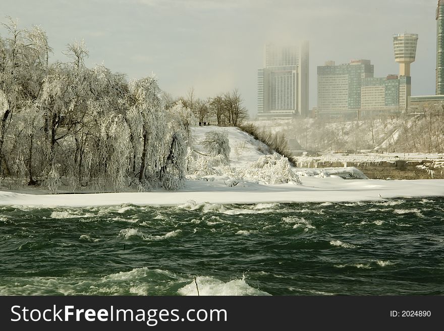 The water rushing towards the Niagara falls in winter time. Ontario Canada visable in the back. The water rushing towards the Niagara falls in winter time. Ontario Canada visable in the back.