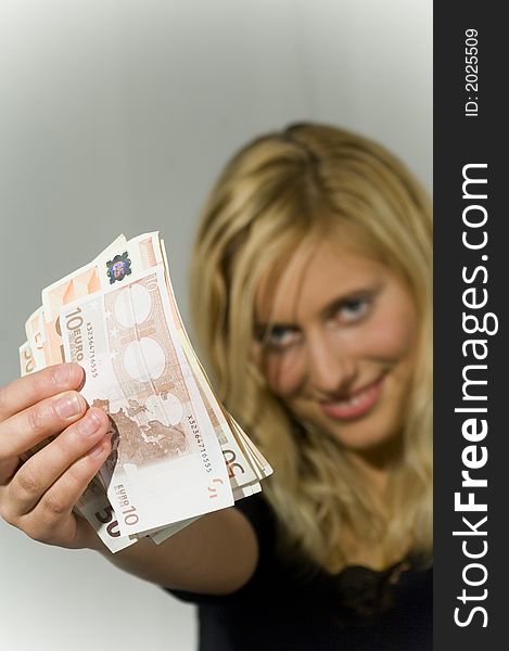 Young blond attractive woman in studio holding money. Young blond attractive woman in studio holding money