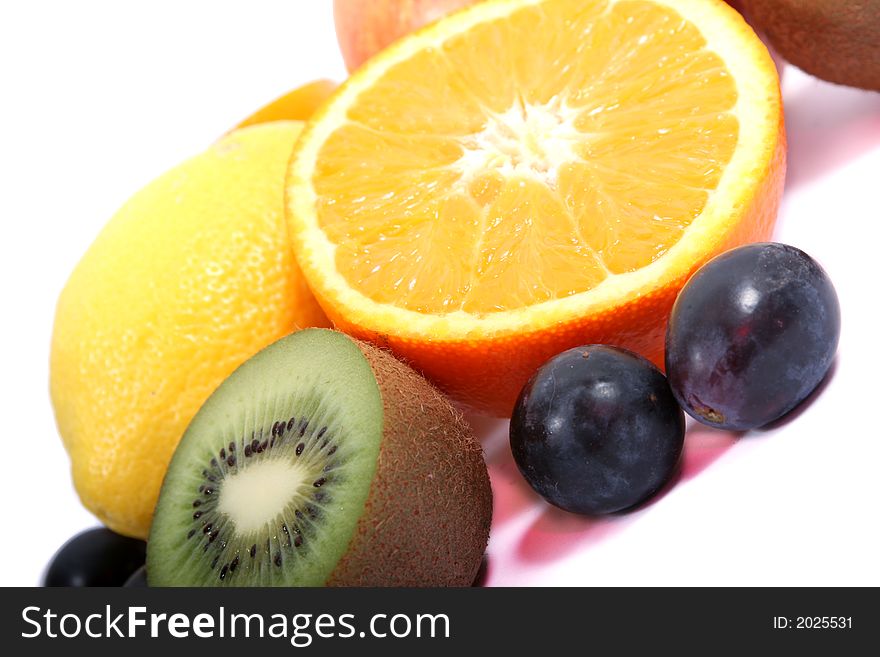 Sliced orange and other fruits on the white background. Sliced orange and other fruits on the white background