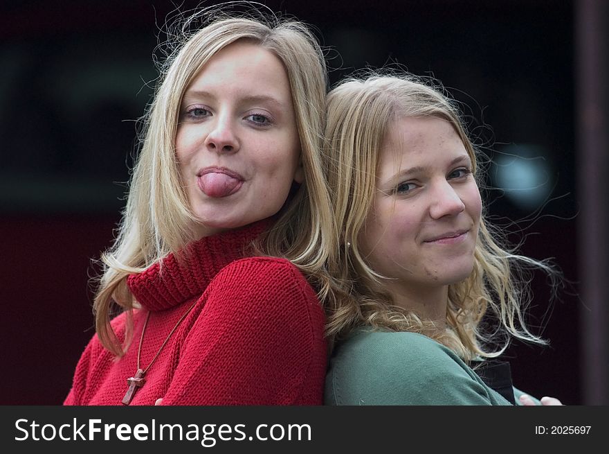 Two young blond women standing on stairs. Two young blond women standing on stairs