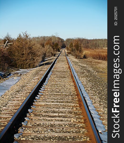 A perspective shot of some railroad tracks on a Winters day. A perspective shot of some railroad tracks on a Winters day.