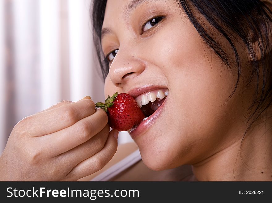 Woman Eating Strawberry