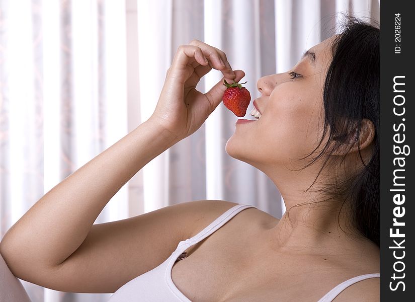 Pregnant woman enjoying her strawberry. Pregnant woman enjoying her strawberry