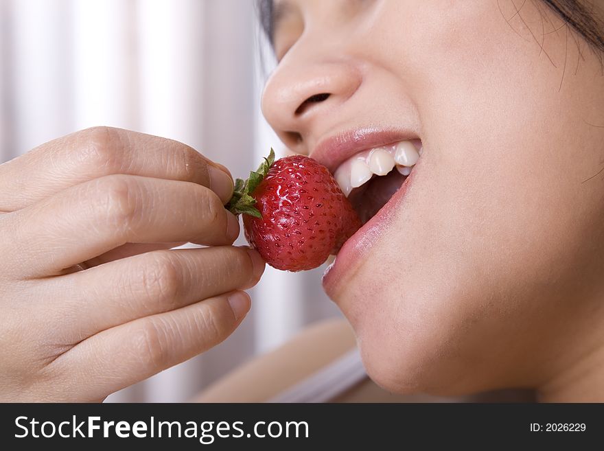 Pregnant woman enjoying her strawberry. Pregnant woman enjoying her strawberry