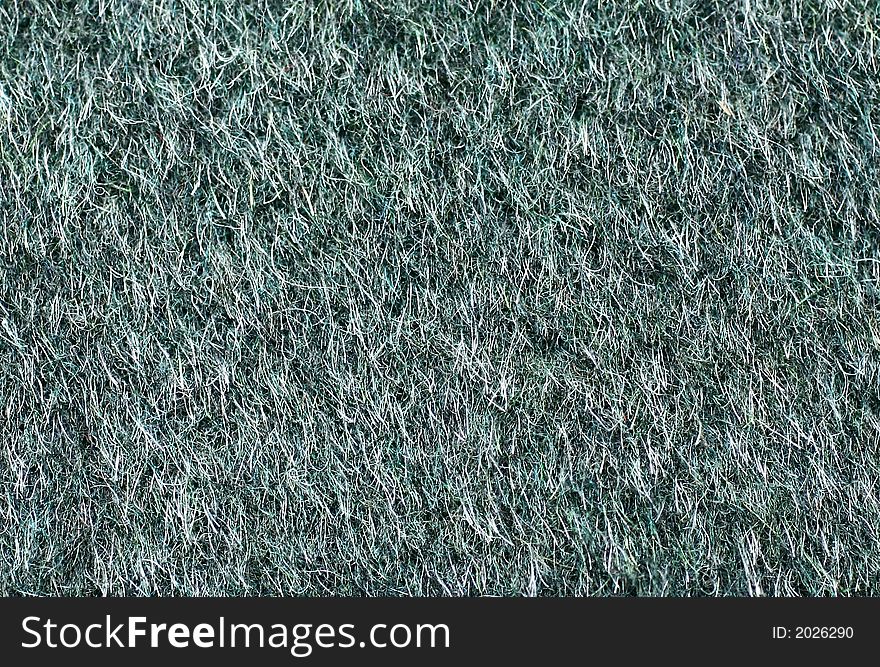Textile background in cyan-green, with hairs in close-up
