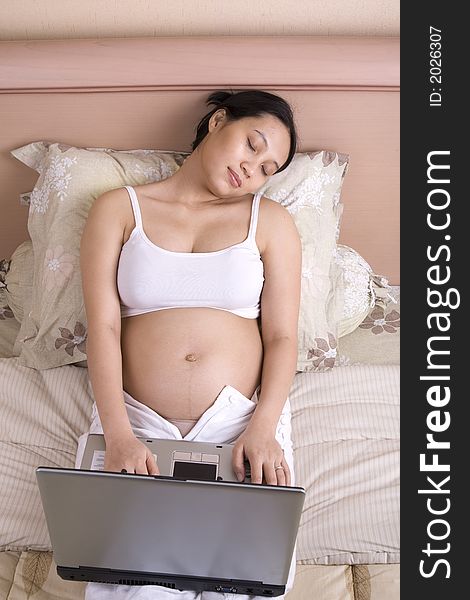 Pregnant businesswoman working on laptop. Pregnant businesswoman working on laptop