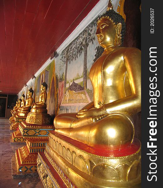 Row of Buddha statues in Thailand temple