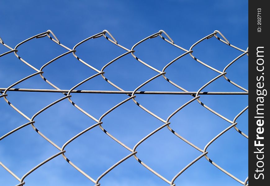 Chain link fance and blue sky. Chain link fance and blue sky