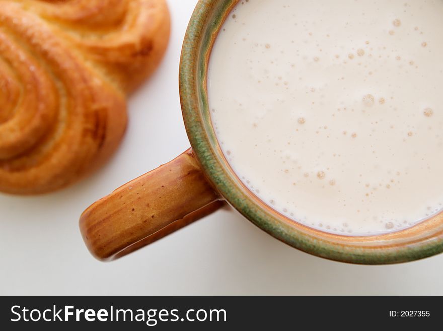 Traditional breakfast of cup of sour milk and golden bun. Traditional breakfast of cup of sour milk and golden bun