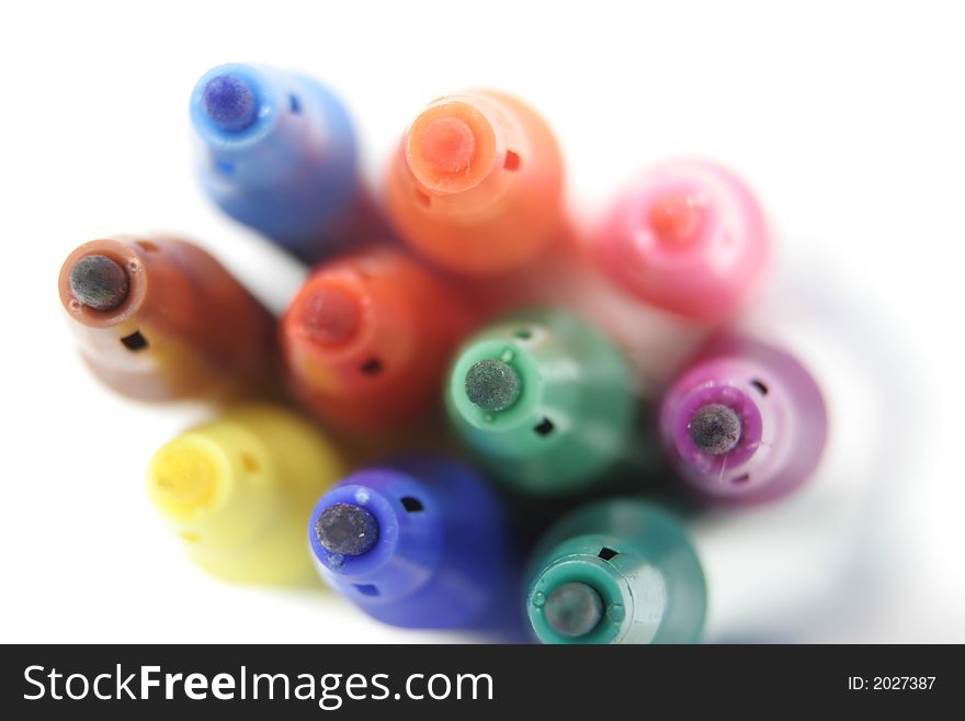 Coloured pens against a white background