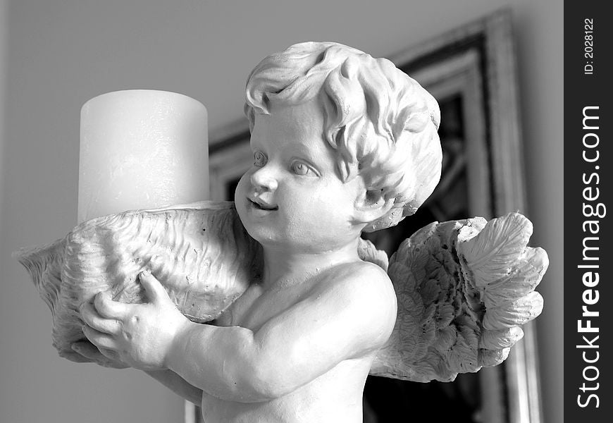 Cherub statue candle holder in black and white. Cherub statue candle holder in black and white