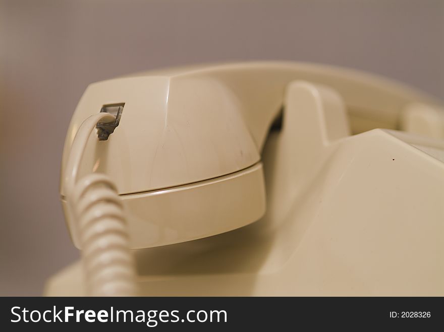 Close up of phone cord inserted into the phone receiver. Close up of phone cord inserted into the phone receiver.