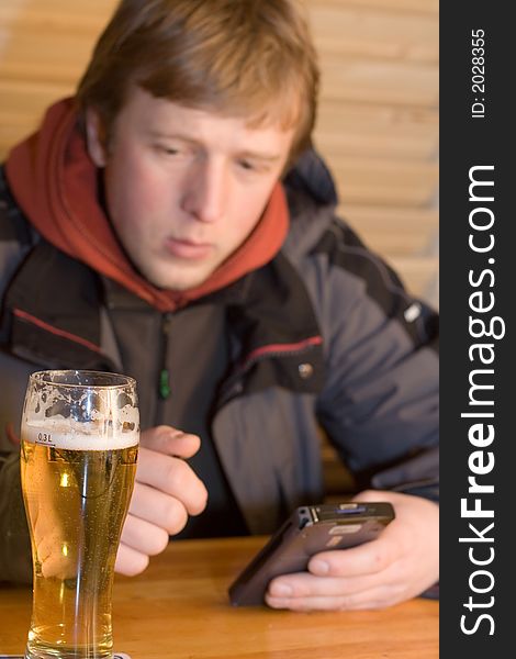 Man with beer and portable