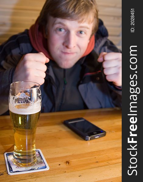 Fan with beaker of beer and palm-size computer. Fan with beaker of beer and palm-size computer.