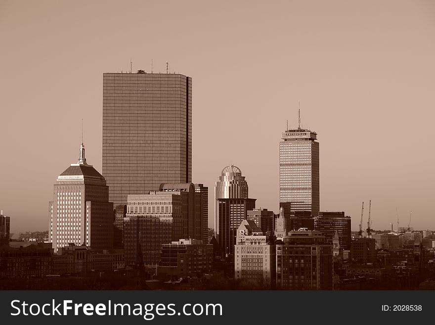 Sepia toned sun rising over Boston on a winter day. Sepia toned sun rising over Boston on a winter day.