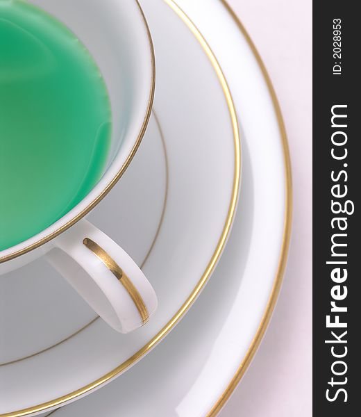 Green Herbal tea in a tea cup on saucer. Green Herbal tea in a tea cup on saucer