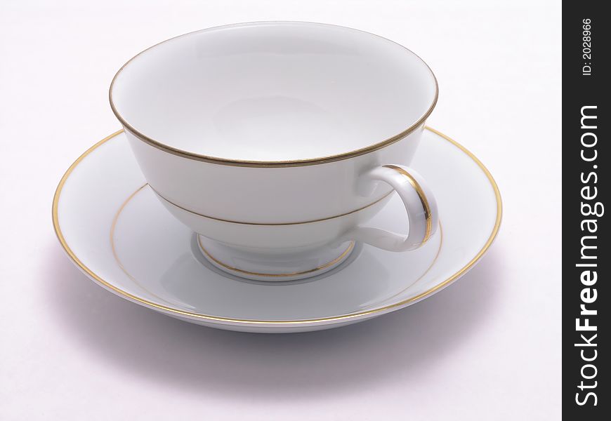 Tea cup and saucer with gold trim. Tea cup and saucer with gold trim