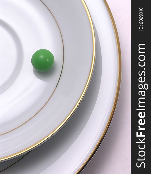 Green candy ball on saucer and plate. Green candy ball on saucer and plate