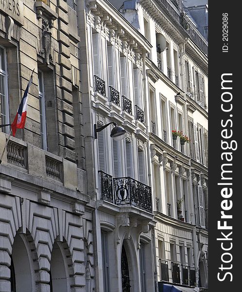 Elegant French buildings in Paris France displaying the French flag. Elegant French buildings in Paris France displaying the French flag