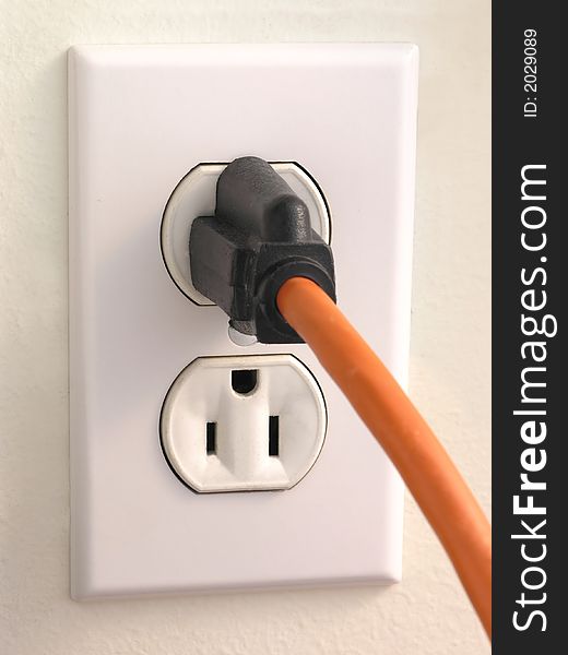 Wall Outlet with Orange corded Plug. Wall Outlet with Orange corded Plug