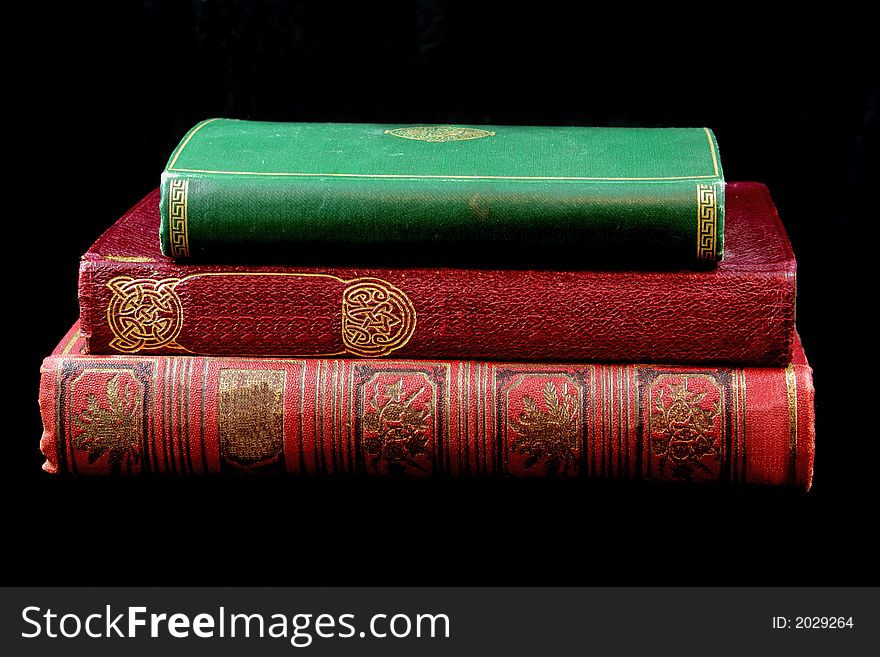 Stack of antique books against black background