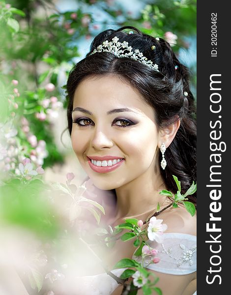 The image of a beautiful bride in a blossoming garden
