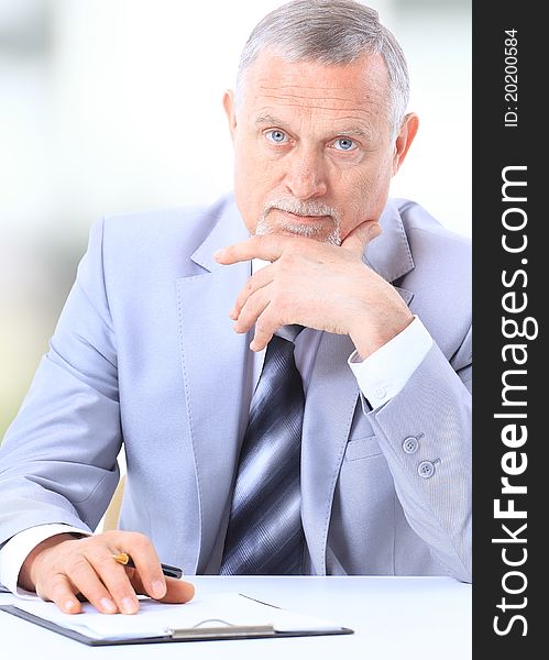 Businessman writing a document in his office. Businessman writing a document in his office