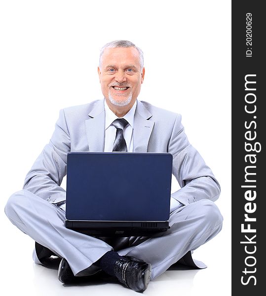 Executive sitting on the floor cross-legged with laptop. Executive sitting on the floor cross-legged with laptop