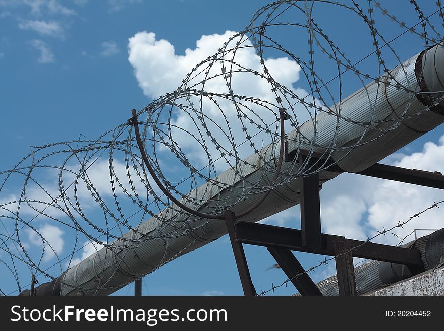 Barbed wire on blue sky background. Barbed wire on blue sky background