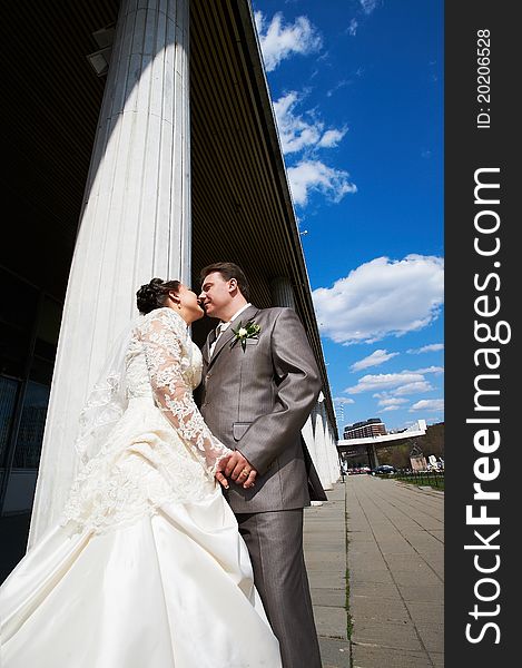 Romantic bride and groom near columns