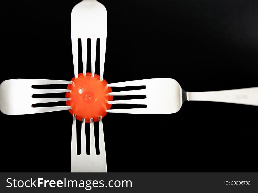 Red Vegetable with forks on black background