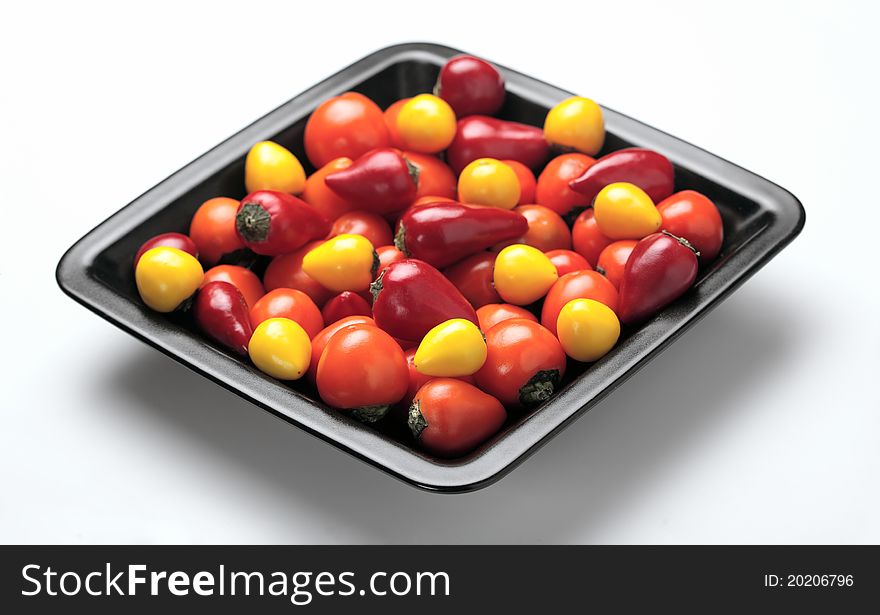 Colorful assortment of peppers on metallic plate. Colorful assortment of peppers on metallic plate