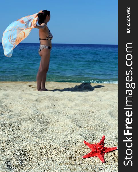 Beach scene, attractive female enjoying summer vacation in Sithonia, Greece
