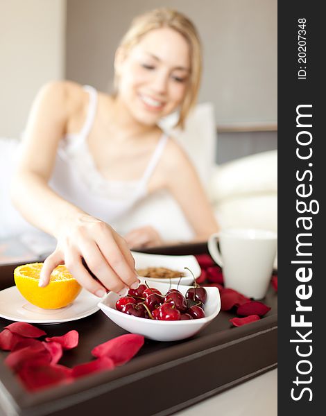 Happy woman having healthy breakfast at the bed. Happy woman having healthy breakfast at the bed