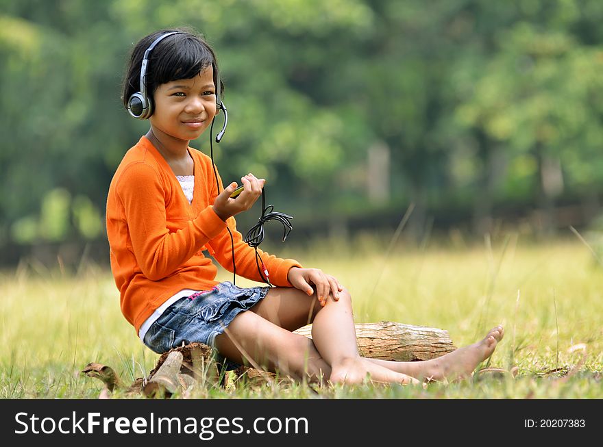 Cute asian girl using a headset and a microphone. Cute asian girl using a headset and a microphone