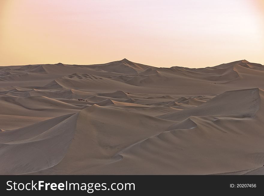 Sand dunes against a pale sunset. Sand dunes against a pale sunset
