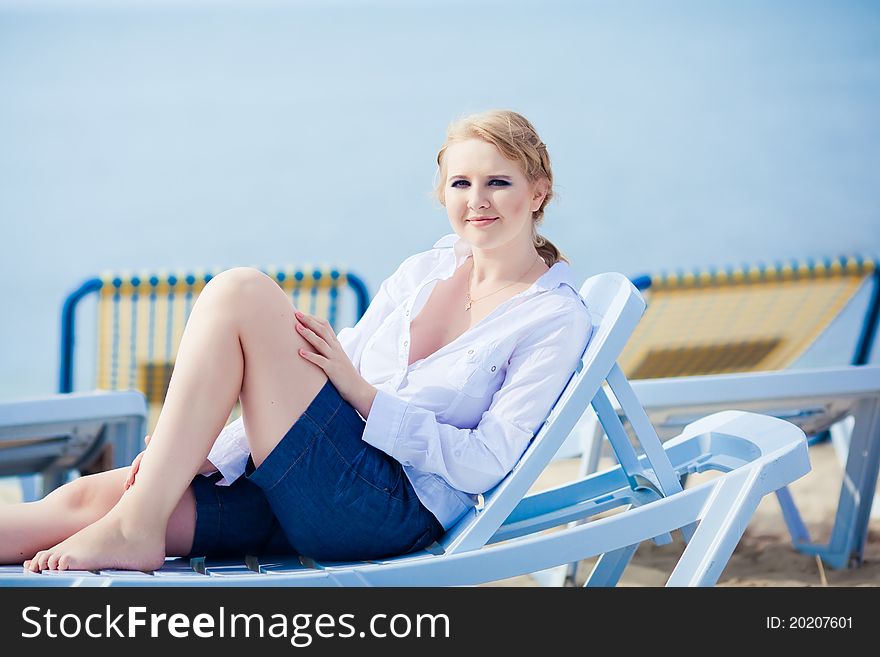 Beautiful Woman Sitting In Chaise