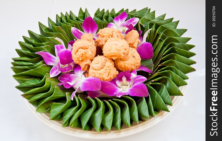 Cookie on orchid flower and banana leaf for eating