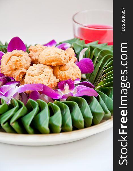 Cookie on orchid flower and banana leaf for eating