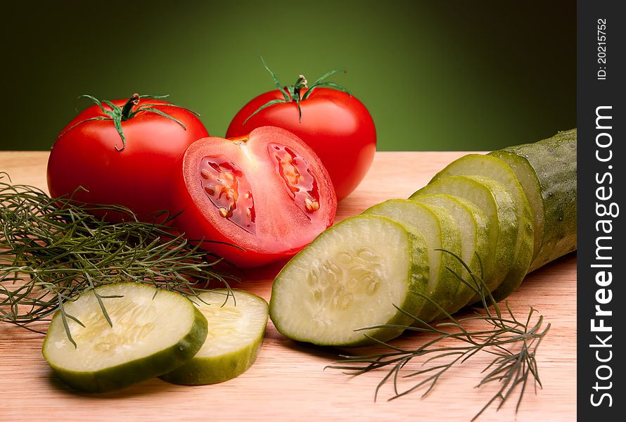 Still life of ripe tomatoes and cucumber. Still life of ripe tomatoes and cucumber