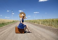 Lonely Girl With Suitcase At Country Road. Royalty Free Stock Photos Lonely Girl With Suitcase At Country Road. Royalty Free Stock Photos