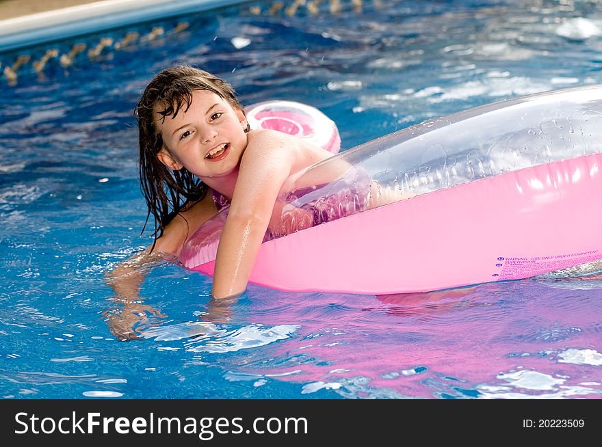 Picture of a young girl playing in a pool. Picture of a young girl playing in a pool