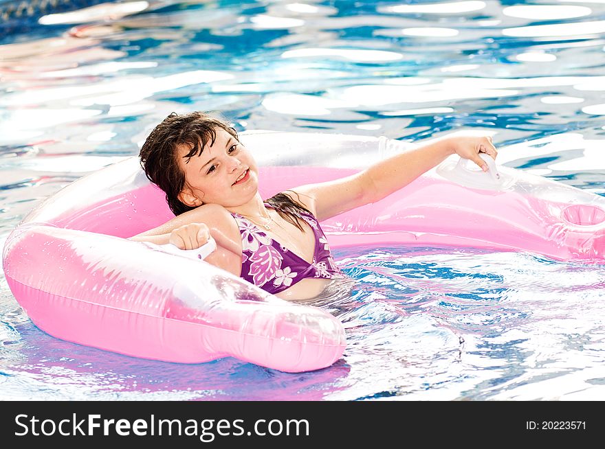 Picture of a young girl playing in a pool. Picture of a young girl playing in a pool
