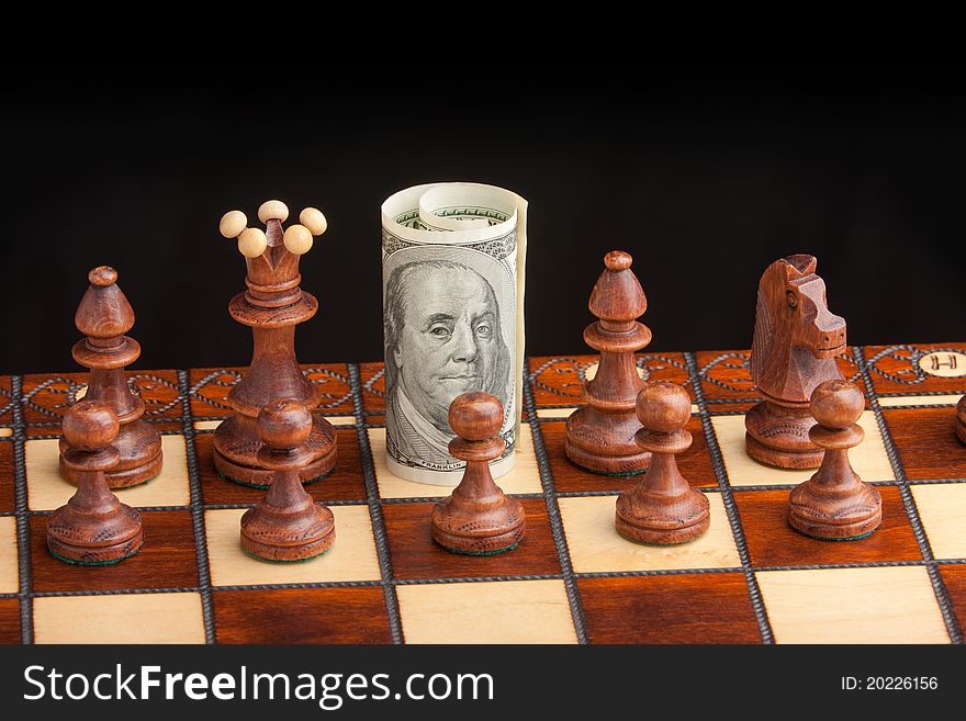 Chess and dollar isolated on a black background