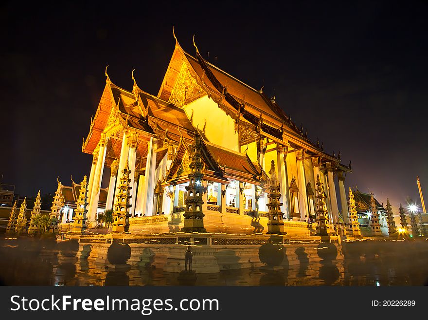 Wat Suthat is one of the oldest and largest temples in Bangkok, famed for its beautiful roofline, huge golden Buddha, magnificent frescoes and giant swing out front. This shot was taken in a night of a buddhist holiday,Wan Wisakha Bucha. Thousand of Buddhists were walking around the temple to pay their respect. Wat Suthat is one of the oldest and largest temples in Bangkok, famed for its beautiful roofline, huge golden Buddha, magnificent frescoes and giant swing out front. This shot was taken in a night of a buddhist holiday,Wan Wisakha Bucha. Thousand of Buddhists were walking around the temple to pay their respect.