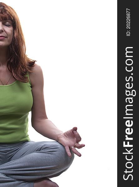 Redhead woman practicing yoga isolated