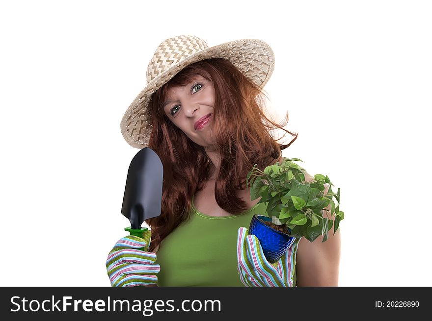 Redhead woman working in the garden with straw hat