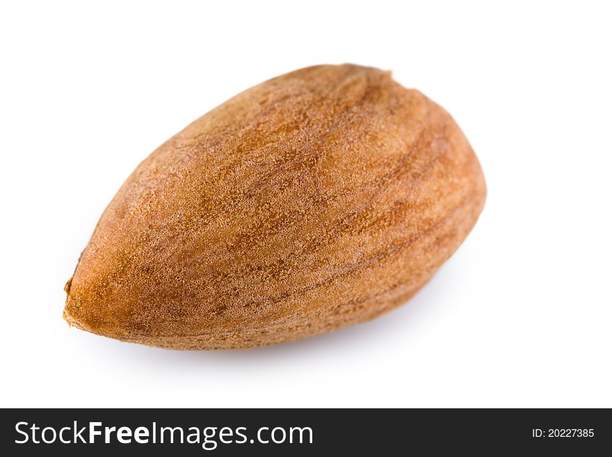 Single almond nut on a white background